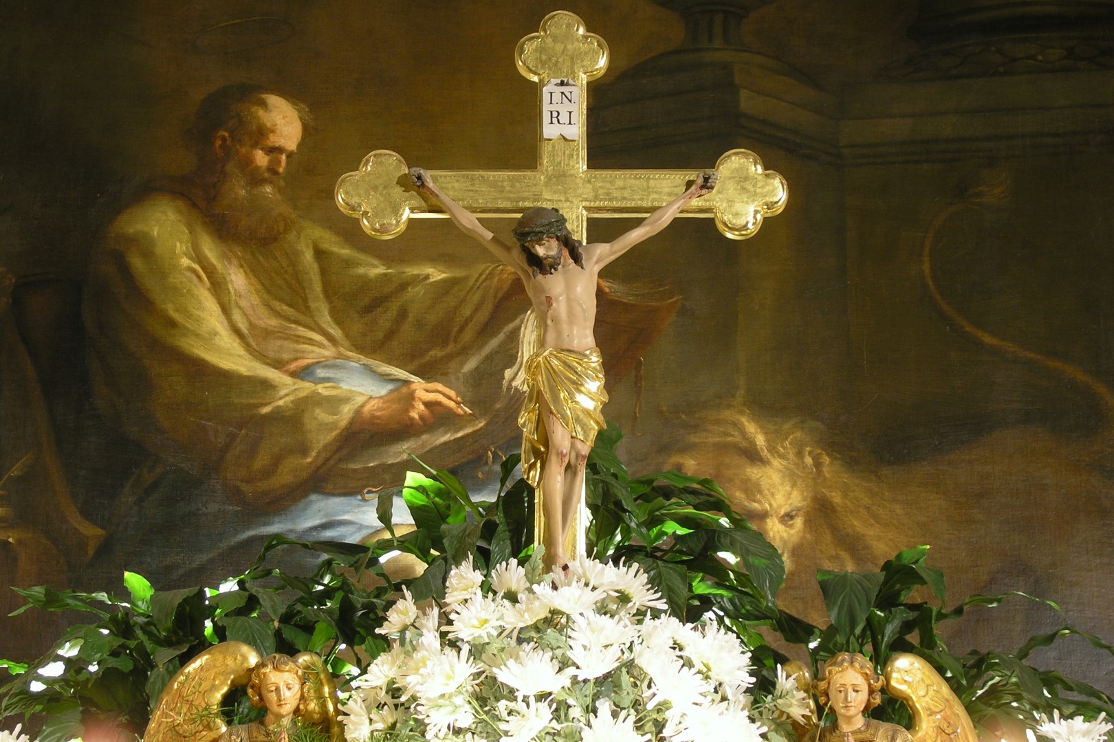 Hochaltarkreuz in der Markuskirche Wolfsberg, im Hintergrund das Altarbild mit dem Hl. Markus (© Mag. Bernhard Wagner).